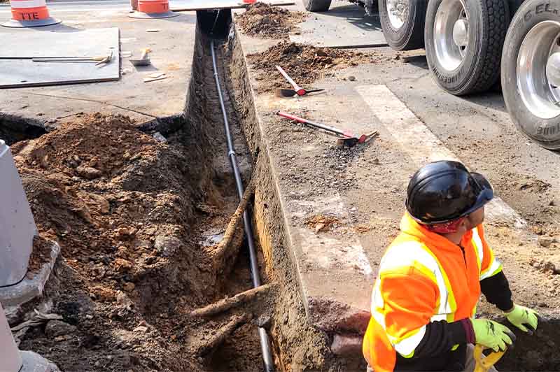 Underground electric line installation in NYC with conduit trenching